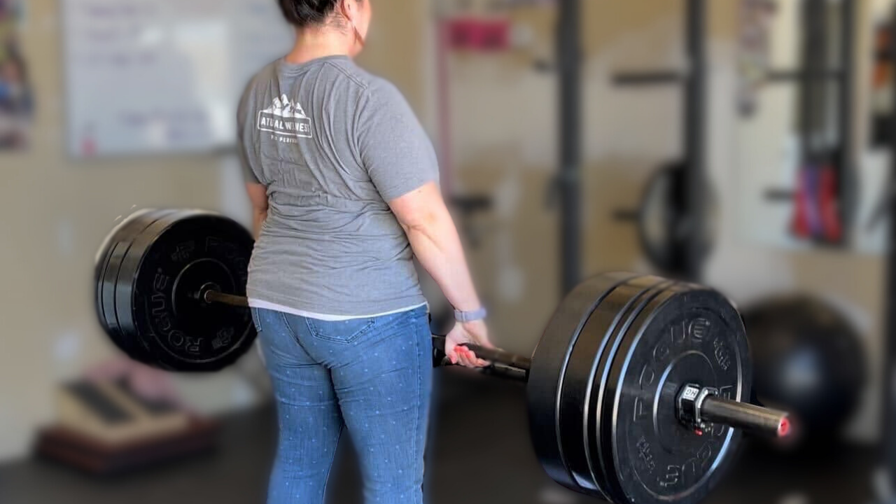 Tina, our client liaison at Natural Wellness Physiotherapy, deadlifts in an impromptu session in our East Wichita gym and physical therapy clinic.